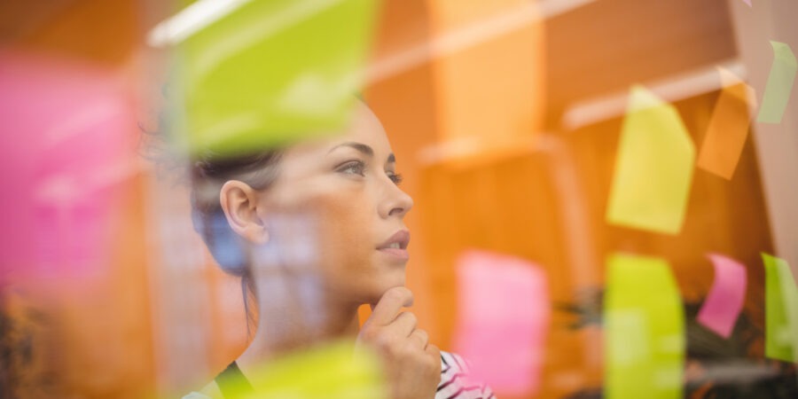 Female executive reading sticky notes
